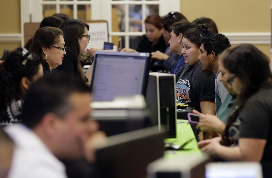 Affordable Care Act navigators help guide those looking for insurance during an enrollment event in San Antonio. (Associated Press)