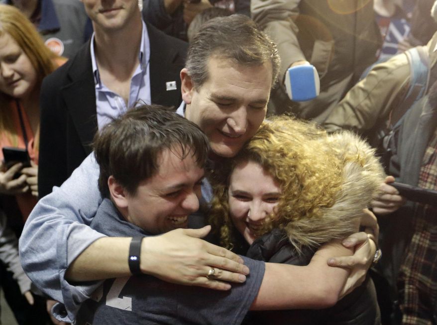 Republican presidential candidate, Sen. Ted Cruz, R-Texas, hugs Arden Jurskis and Kenzy Peach after Arden proposed Kenzy in front of Cruz at a campaign event at Iowa State Fairgrounds, Sunday, Jan. 31, 2016, in Des Moines, Iowa. Kenzy said yes. (AP Photo/Chris Carlson)