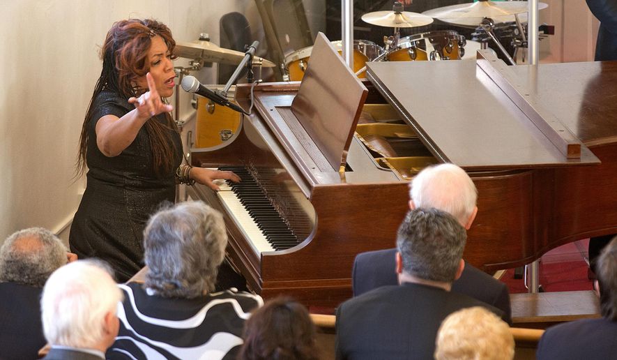 Valerie Simpson performs during a ceremony at First Baptist Church on Monday, Feb. 1, 2016, in Williamsburg, Va. The long-silent bell at the historic Williamsburg church sounded to launch the congregation's 240th anniversary throughout Black History Month. (Joe Fudge/The Daily Press via AP) MANDATORY CREDIT