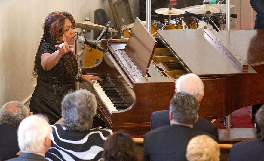 Valerie Simpson performs during a ceremony at First Baptist Church on Monday, Feb. 1, 2016, in Williamsburg, Va. The long-silent bell at the historic Williamsburg church sounded to launch the congregation's 240th anniversary throughout Black History Month. (Joe Fudge/The Daily Press via AP) MANDATORY CREDIT