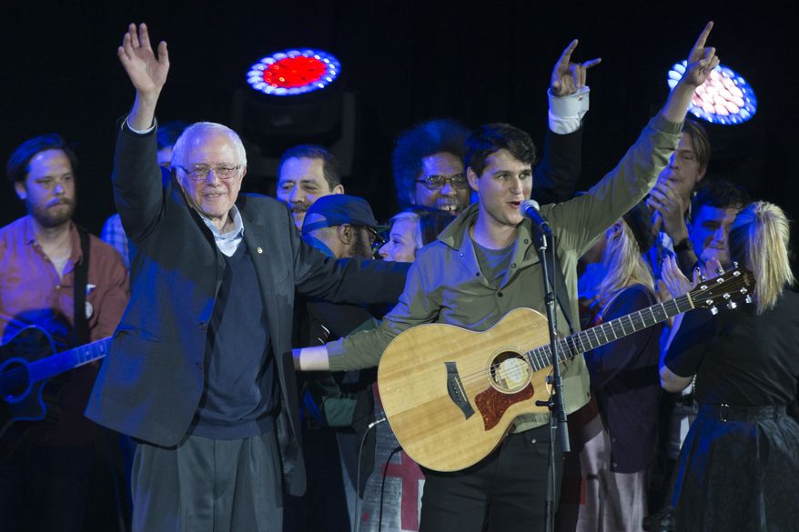 Democratic presidential candidate Sen. Bernie Sanders, I-Vt., left, and Vampire Weekend lead singer Ezra Koenig wave during a campaign rally at the University of Iowa, Saturday, Jan. 30, 2016, in Iowa City, Iowa. (AP Photo/Evan Vucci) ** FILE **