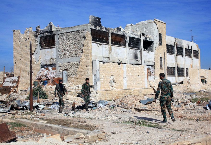 This Wednesday, Nov. 11, 2015, file photo released by the Syrian official news agency SANA, shows Syrian government troops walk inside the Kweiras air base, east of Aleppo, Syria. (SANA via AP, File)