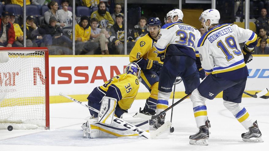 St. Louis Blues right wing Troy Brouwer (36) watches as his tip-in gets past Nashville Predators goalie Pekka Rinne (35), of Finland, for a goal in the third period of an NHL hockey game Tuesday, Feb. 2, 2016, in Nashville, Tenn. The goal gave the Blues a 1-0 win. Looking on are Blues' defenseman Jay Bouwmeester (19) and Predators defenseman Shea Weber (6). (AP Photo/Mark Humphrey)