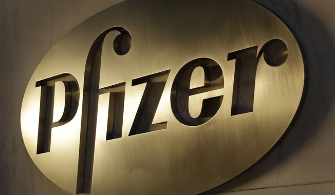FILE - In this Monday, Nov. 23, 2015, file photo, the Pfizer logo is displayed at world headquarters, in New York. Pfizer reports financial results, Tuesday, Feb. 2, 2016. (AP Photo/Mark Lennihan, File)