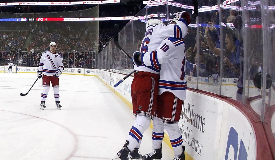 New York Rangers center J.T. Miller (10) and center Derick Brassard (16) celebrate Miller's goal against the New Jersey Devils during the first period of an NHL hockey game, Tuesday, Feb. 2, 2016, in Newark, N.J. (AP Photo/Julio Cortez)