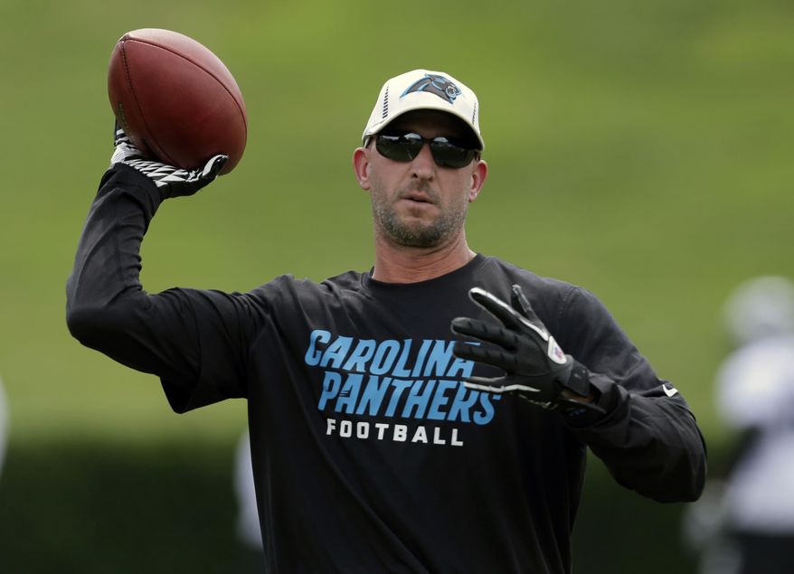 FILE - In this Saturday, July 27, 2013 file photo, Carolina Panthers receivers coach Ricky Proehl throws a pass during an NFL football training camp practice in Spartanburg, S.C. The pain of losing a Super Bowl never really disappears. It drives players who have experienced it to get back and get it right. Ricky Proehl has been to four Super Bowls as a player, going 2-2. He won and lost with the Rams, lost with the Panthers, and got the second ring in his final NFL season, 2006 with Indianapolis. (AP Photo/Chuck Burton, File)