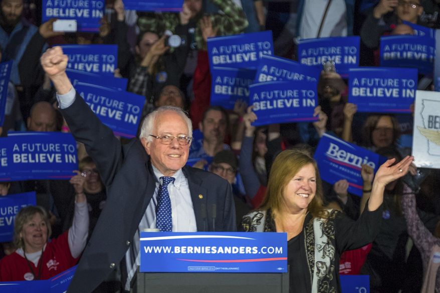 Democratic presidential candidate, Sen. Bernie Sanders, I-Vt, and his wave Jane acknowledge the crowd as he arrives for his caucus night rally in Des Moines, Iowa, Monday, Feb. 2, 2016. (AP Photo/J. David Ake)