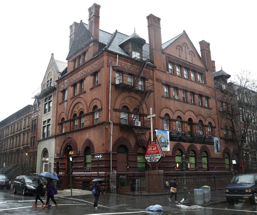 The outside of the Atlah Church is seen in the Harlem section of New York, Wednesday, Feb. 3, 2016. Two groups that serve gay New Yorkers are hoping to get the last word on the Atlah World Missionary Church. They want to buy its headquarters at a foreclosure auction. One wants to turn it into housing for gay homeless youth. (AP Photo/Seth Wenig)