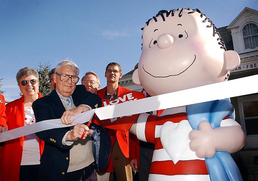 FILE - In a Sept. 23, 2003 file photo, the real Linus, artist Linus Maurer, cuts a ribbon after unveiling a statue of Linus of "Peanuts" comic strip fame during a ceremony at his hometown of Sleepy Eye, Minn. Maurer, a cartoonist and illustrator whose old friend Charles Schulz borrowed his first name for Charlie Brown’s sidekick in his “Peanuts” comic strip, has died. Maurer’s longtime partner Mary Jo Starsiak said Friday, Feb. 5, 2016, that Maurer died Jan. 29 in Sonoma, California. He was 90. (John Cross/The Free Press via AP)