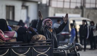 A Syrian man gestures as Syrians gather at the border gate with Turkey, in Bab al-Salam, Syria, Saturday, Feb. 6, 2016. Thousands of Syrians have rushed toward the Turkish border, fleeing fierce Syrian government offensives and intense Russian airstrikes. Turkey has promised humanitarian help for the displaced civilians, including food and shelter, but it did not say whether it would let them cross into the country. (AP Photo/Bunyamin Aygun) TURKEY OUT