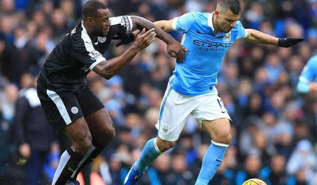 Manchester City&#x27;s Sergio Aguero, right and Leicester City&#x27;s Wes Morgan tussle for the ball during the English Premier League match at the Etihad Stadium, Manchester, England, Saturday Feb. 6, 2016. (Nigel French / PA via AP) UNITED KINGDOM OUT - NO SALES - NO ARCHIVES