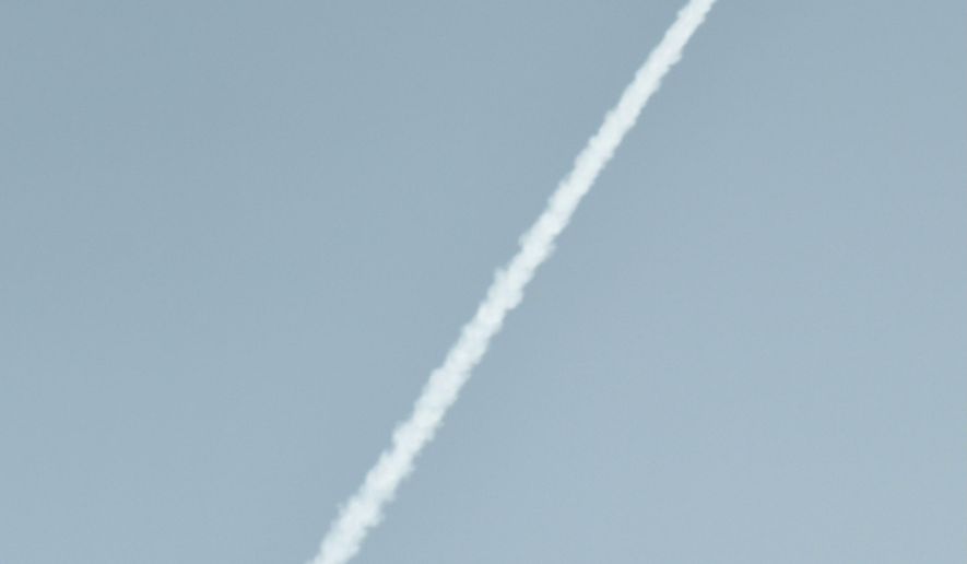 In this image released by Japan's Kyodo News agency, an unidentified object is photographed in the sky from Dandong, China, near the North Korean border, Sunday, Feb. 7, 2016, at the same time a North Korea rocket was allegedly launched. North Korea on Sunday defied international warnings and launched a long-range rocket that the United Nations and others call a cover for a banned test of technology for a missile that could strike the U.S. mainland. (Minoru Iwasaki/Kyodo News via AP) JAPAN OUT, MANDATORY CREDIT