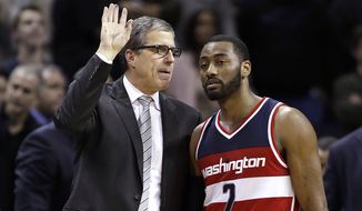 Washington Wizards coach Randy Wittman huddles with John Wall during the second half of the team&#39;s NBA basketball game against the Charlotte Hornets in Charlotte, N.C., Saturday, Feb. 6, 2016. The Hornets won 108-104. (AP Photo/Bob Leverone)