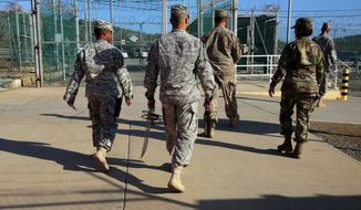 In this Feb. 2, 2016 photo, military guards exit an area known as Camp Delta at the Guantanamo Bay detention center, in Cuba. After 14 years, the detention center appears to be winding down despite opposition in Congress to President Barack Obama&#39;s intent to close the facility and confine the remaining prisoners someplace else. (AP Photo/Ben Fox)
