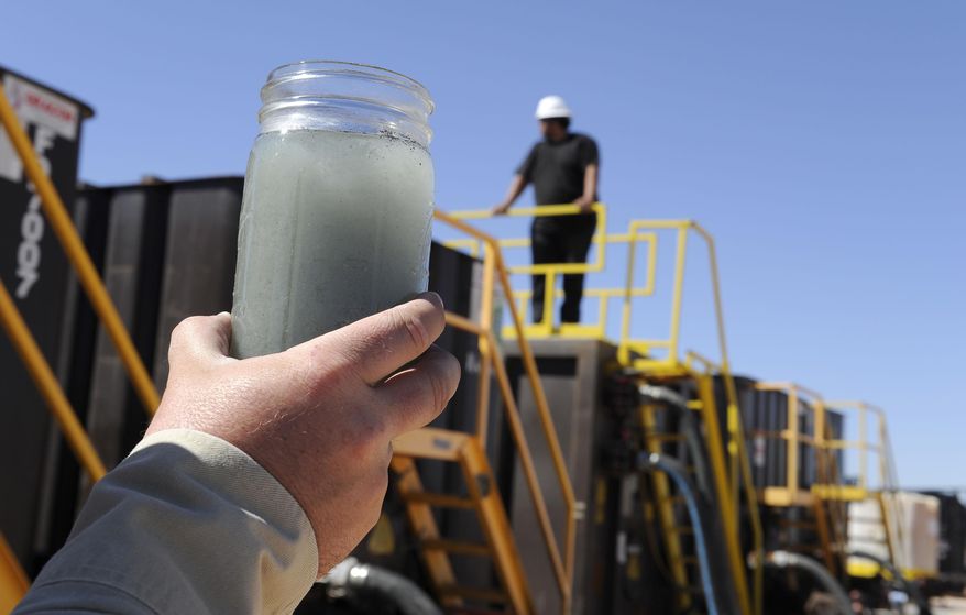 File-This Sept. 24, 2013, file photo shows a jar holding waste water from hydraulic fracturing is held up to the light at a recycling site in Midland, Texas. Texas was among the first states in the country in 2011 to pass a hydraulic fracturing disclosure law, which supporters called a popular and landmark piece of legislation designed to improve transparency. Environmentalists complained, though, that the Texas legislation gave industry-wide latitude in deciding what ingredients to make public. (AP Photo/Pat Sullivan, File)