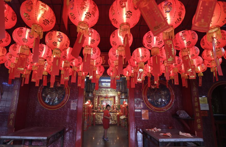 An Indonesian ethnic Chinese walks inside a temple during the celebration of the Lunar New Year at the China Town in Jakarta, Indonesia, Monday, Feb. 8, 2016. The celebration marks the Year of the Monkey in the Chinese calendar.(AP Photo/Dita Alangkara)