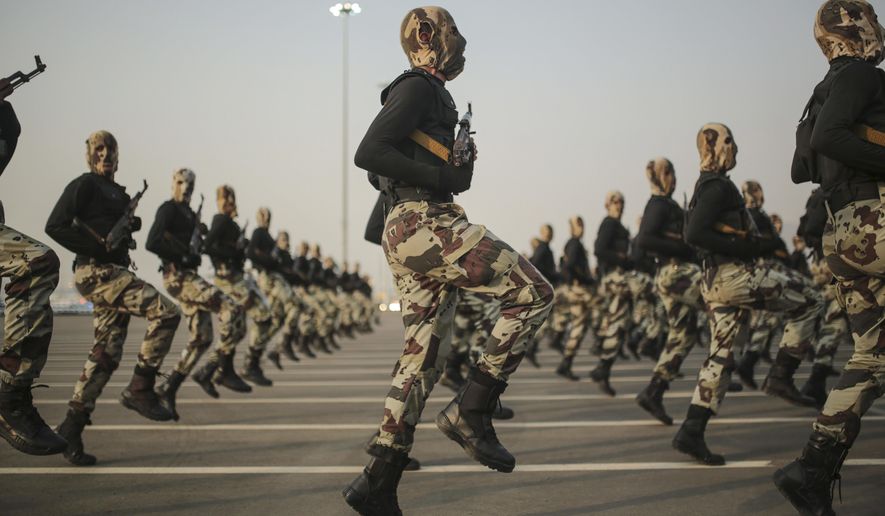 FILE - In this Thursday, Sept. 17, 2015 file photo, Saudi security forces take part in a military parade in preparation for the annual Hajj pilgrimage in Mecca, Saudi Arabia. Saudi Arabia’s offer to put boots on the ground to fight Islamic State in Syria is as much about the kingdom’s growing determination to flex its military might as it is about answering U.S. calls for more help from Mideast allies. (AP Photo/Mosa'ab Elshamy, File)