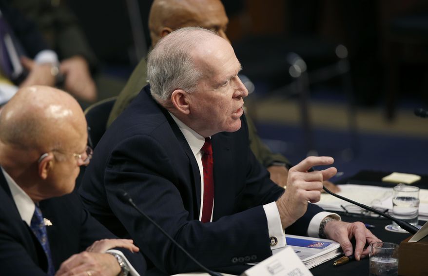 CIA Director John Brennan, flanked by Director of the National Intelligence Director James Clapper, left, and Defense Intelligence Agency Director Lt. Gen. Vincent Stewart, testifies on Capitol Hill in Washington, Tuesday, Feb. 9, 2016, before Senate Intelligence Committee hearing on worldwide threats. (AP Photo/Alex Brandon)