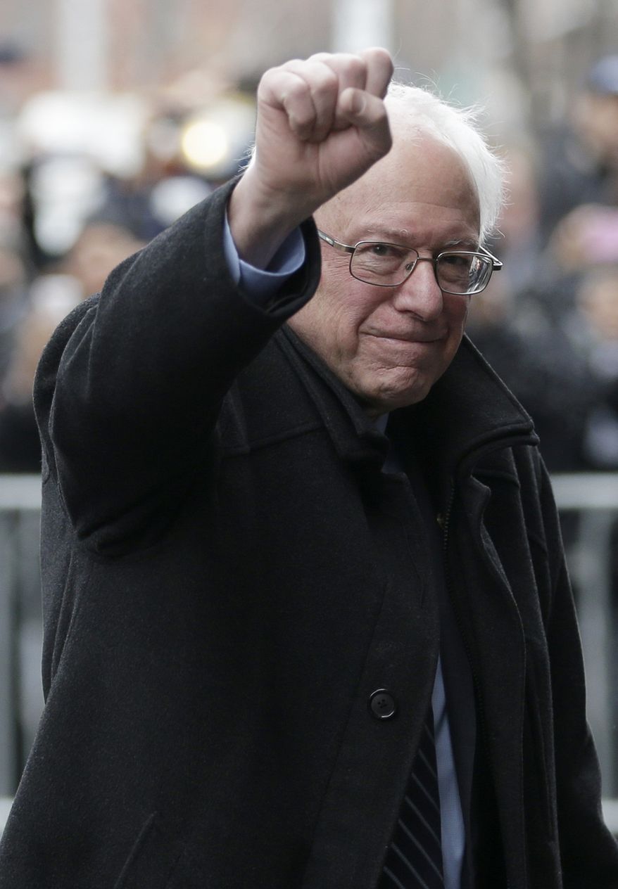 Democratic presidential candidate Sen. Bernie Sanders, I-Vt., raises a fist as he arrives for a breakfast meeting with Al Sharpton at Sylvia's Restaurant, Wednesday, Feb. 10, 2016, in the Harlem neighborhood of New York. Sanders defeated former Secretary of State Hillary Clinton on Tuesday in the New Hampshire primary. (AP Photo/Seth Wenig)