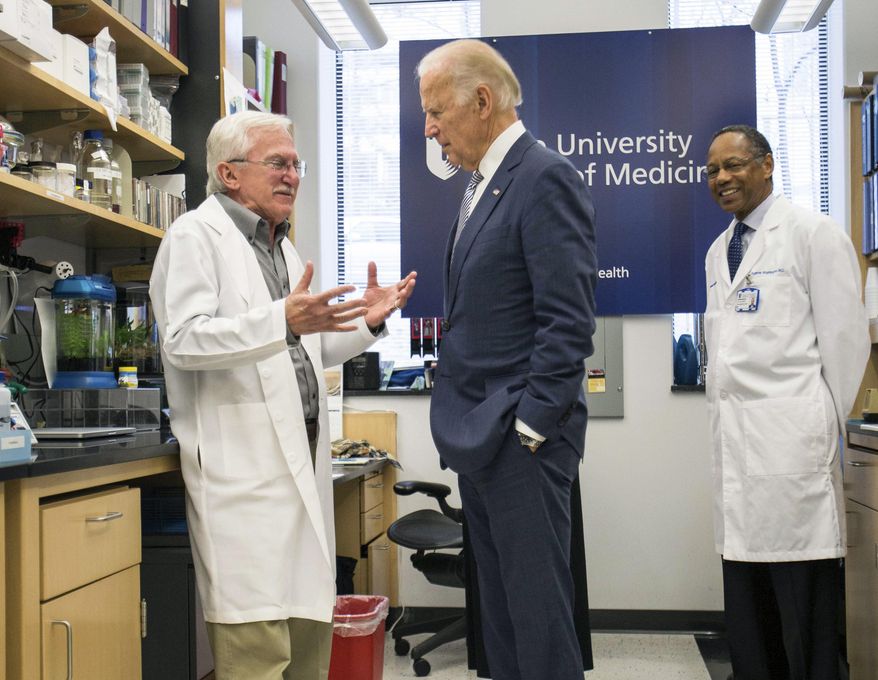 Vice President Joe Biden speaks with Nobel Laureate Dr. Paul Modrich, left, as Dr. A. Eugene Washington, Chancellor for Health Affairs at Duke University, right listens in a laboratory at Duke University School of Medicine in Durham, N.C. Wednesday, Feb. 10, 2016. VBiden visited Duke to speak about his Cancer Moonshot initiative. (AP Photo/Ben McKeown)