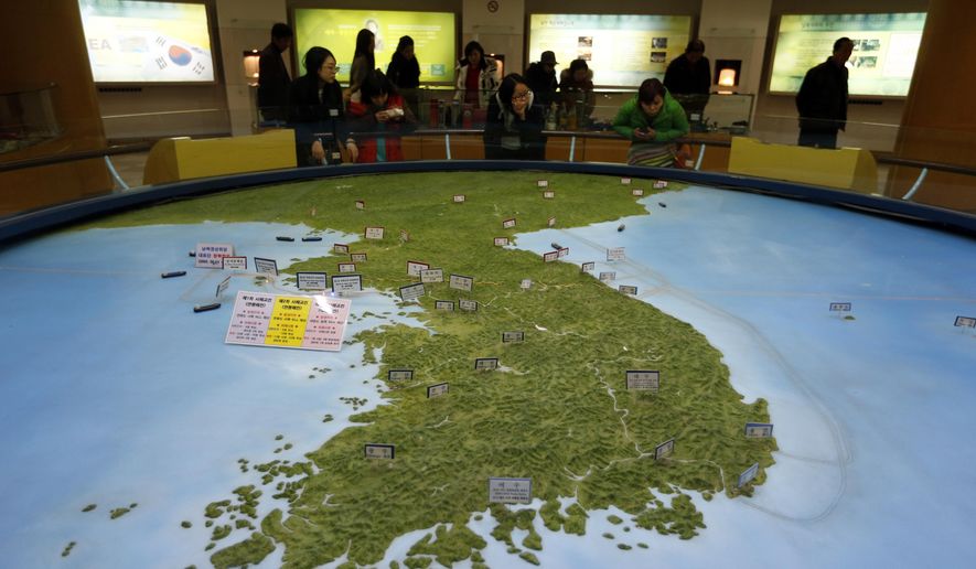 Visitors look at a map of the Korean peninsula at the exhibition hall of the unification observatory in Paju, South Korea, Wednesday, Feb. 10, 2016. South Korea says it will suspend the operations at a joint industrial park with North Korea in response to the North&#39;s recent rocket launch.  (AP Photo/Lee Jin-man) ** FILE **