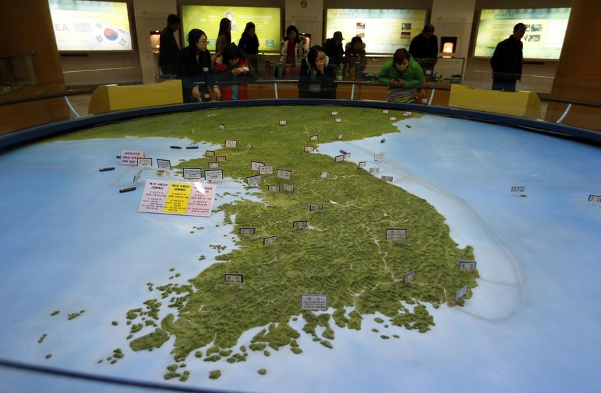 Visitors look at a map of the Korean peninsula at the exhibition hall of the unification observatory in Paju, South Korea, Wednesday, Feb. 10, 2016. South Korea says it will suspend the operations at a joint industrial park with North Korea in response to the North&#39;s recent rocket launch.  (AP Photo/Lee Jin-man) ** FILE **