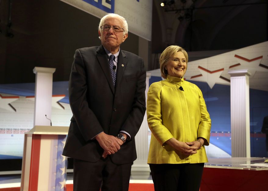 Democratic presidential candidates Sen. Bernard Sanders of Vermont and Hillary Clinton take the stage before a Democratic presidential primary debate at the University of Wisconsin-Milwaukee on Thursday. (Associated Press)