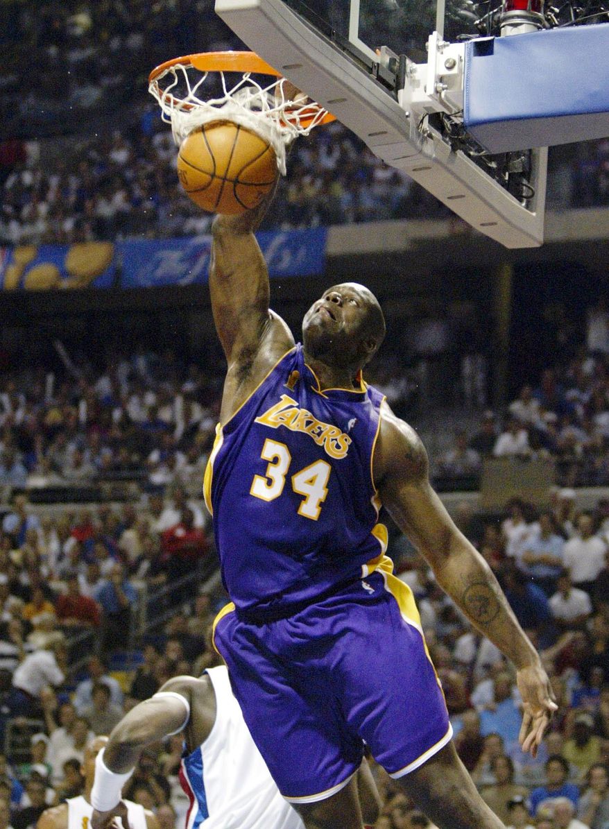 FILE - In this June 15, 2004, file photo, Los Angeles Lakers Shaquille O'Neal (34) dunks the ball against the Detroit Pistons in Game 5 of the NBA Finals in Auburn Hills, Mich. This year's Hall of Fame class includes a star-studded field of potential finalists, including Shaquille O'Neal, Yao Ming and Allen Iverson. That trio should be a lock to get in. (AP Photo/ Michael Conroy, File)