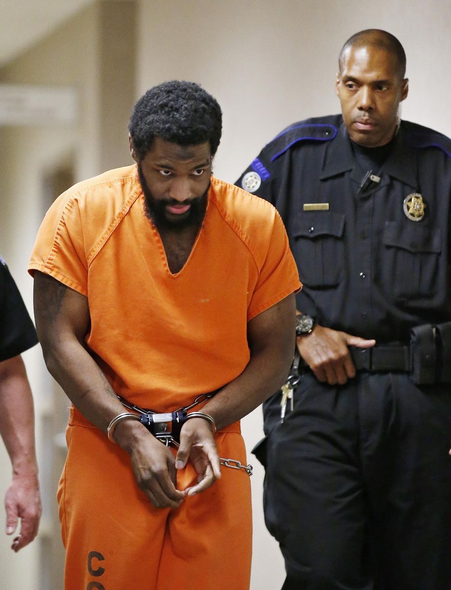 FILE - In this Friday, Jan. 8, 2016 file photo, Alton Nolen is led from the courtroom following his preliminary hearing in Norman, Okla. Nolen, accused of beheading a co-worker with a large butcher knife at an Oklahoma food processing plant, was arraigned Thursday for the September 2014 attack at the Vaughan Foods plant in Moore, Okla. (AP Photo/Sue Ogrocki, File)