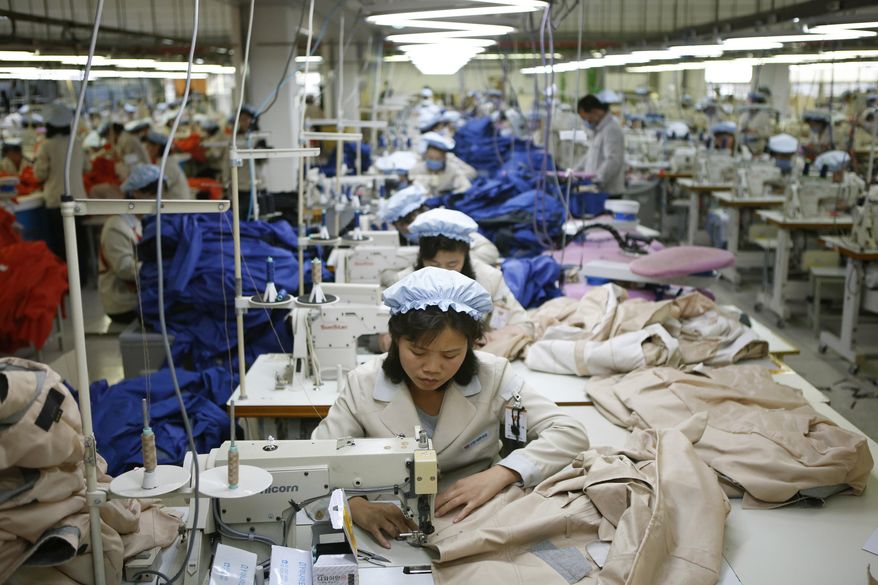 FILE - In this Dec. 19, 2013, file photo, North Korean workers assemble jackets at a factory of a South Korean-owned company at the jointly-run Kaesong Industrial Complex, in Kaesong, North Korea. The closure of a factory park in North Korea jointly run by both Koreas has robbed the impoverished North of a rare source of legitimate hard currency. (Kim Hong-Ji/Pool Photo via AP, File)