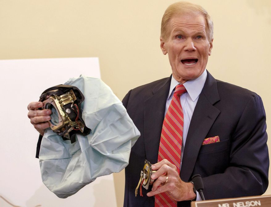 FILE - In this Nov. 20, 2014 file photo, Senate Commerce Committee member Sen. Bill Nelson, D-Fla. holds an example of the defective airbag made by Takata of Japan that has been linked to multiple deaths and injuries in cars driven in the U.S. during the committee's hearing on Capitol Hill in Washington. According to documents posted Friday, Feb. 12, 2016, on the National Highway Traffic Safety Administration website, Volkswagen resisted U.S. government efforts to recall more cars and trucks to fix potentially deadly Takata air bags — telling safety regulators that a recall isn't necessary. But the German automaker, already in hot water with the government for cheating on U.S. pollution tests, eventually agreed to the recall. (AP Photo/J. Scott Applewhite, File)