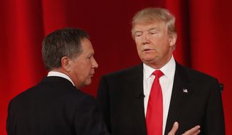 Ohio Gov. John Kasich (left) speaks to businessman Donald Trump  during a commercial break during the CBS News Republican presidential debate at the Peace Center in Greenville, S.C., on Feb. 13, 2016. (Associated Press) **FILE**