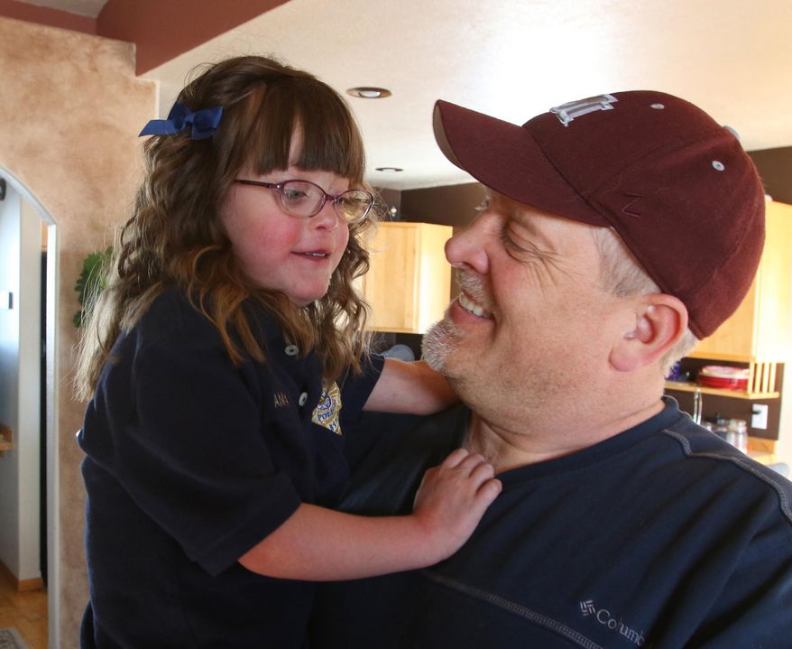 Wayne Halvorsen, right, laughs with his 6-year-old daughter Annalyn at their home in Butte, Mont., on Feb. 5, 2016. Annalyn was born six weeks early and within a day was diagnosed with hypoplastic left heart syndrome, a rare heart defect that causes the heart to be severely under-developed. (Walter Hinick/The Montana Standard via AP) MANDATORY CREDIT