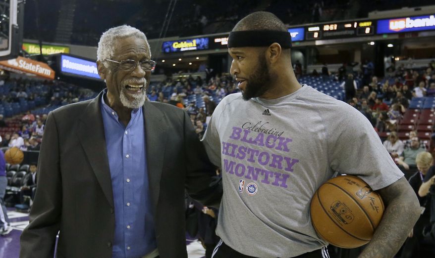 NBA legend  Bill Russell, left, talks with Sacramento Kings center DeMarcus Cousins before the Kings played the Dallas Mavericks  in an NBA basketball game in Sacramento, Calif., Thursday,  Feb. 5, 2015.(AP Photo/Rich Pedroncelli)