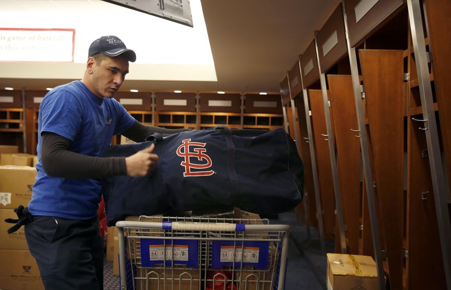 Dustin Heddy with United Van Lines packs up gear in the St. Louis Cardinals clubhouse to be sent to the baseball team's spring training facility Thursday, Feb. 11, 2016, in St. Louis. Cardinals pitchers and catchers are scheduled to report to camp on Feb. 17, 2016, in Jupiter, Fla. (AP Photo/Jeff Roberson)