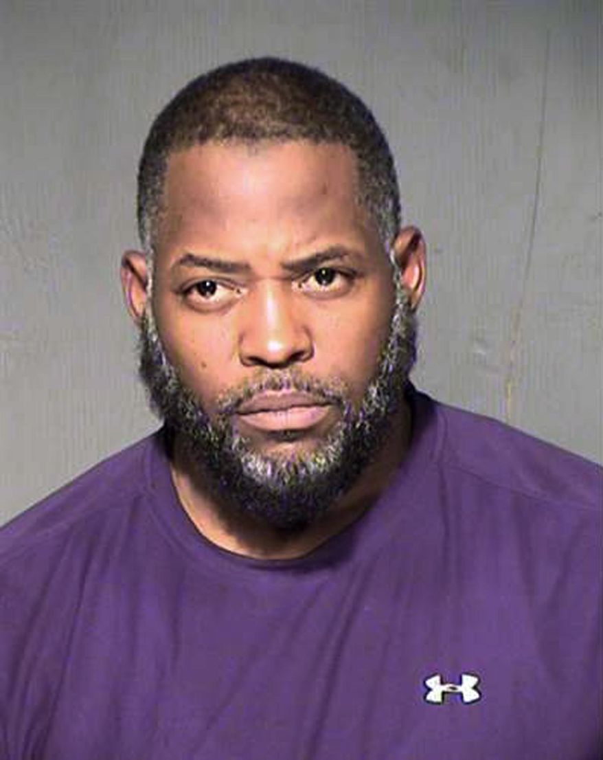 FILE - This undated file booking photo from the Maricopa County, Ariz., Sheriff's Department shows Abdul Malik Abdul Kareem. The Arizona man is set for trial Tuesday, Feb. 16, 2016, on terror charges linked to Islamic State. Kareem is accused of providing the guns used in an attack at a Prophet Muhammad cartoon contest in Texas. (Maricopa County Sheriff's Department via AP, File)