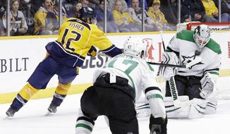 Dallas Stars goalie Antti Niemi, of Finland, holds the puck in place with his mask as Nashville Predators forward Mike Fisher (12) reaches for a possible rebound in the second period of an NHL hockey game Monday, Feb. 15, 2016, in Nashville, Tenn. (AP Photo/Mark Humphrey)