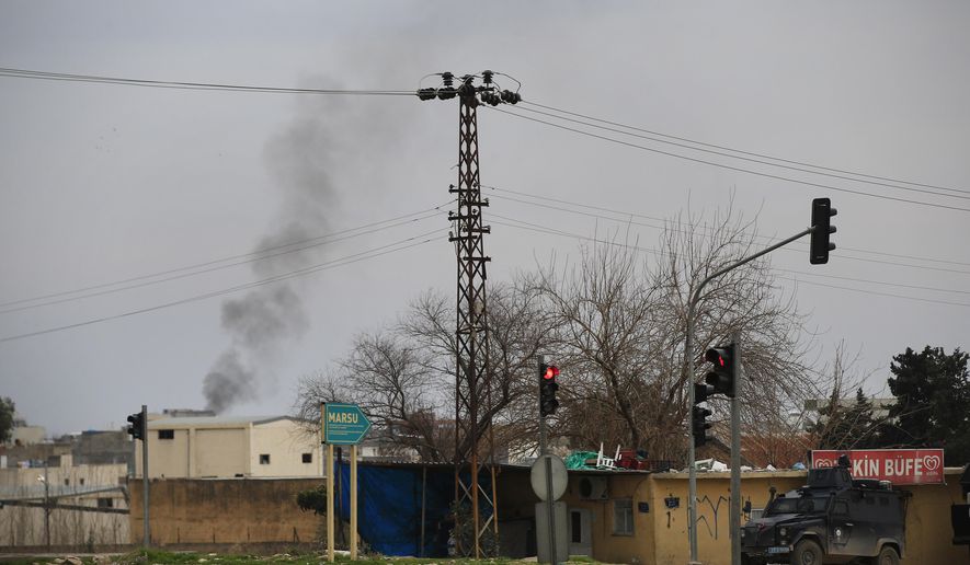 Smoke billows from a fire at the southeastern town of Nusaybin, Turkey, near the border with Syria, where Turkish security forces are battling militants linked to the outlawed Kurdistan Workers, Party or PKK, Sunday, Feb. 14, 2016, a day after Turkish media reports said a police officer was injured in a clash. The private Dogan news agency said the militants on Saturday detonated an explosive device in the town as a military vehicle was passing by, but no one injured. A second bomb was defused in a controlled explosion. (AP Photo/Lefteris Pitarakis)