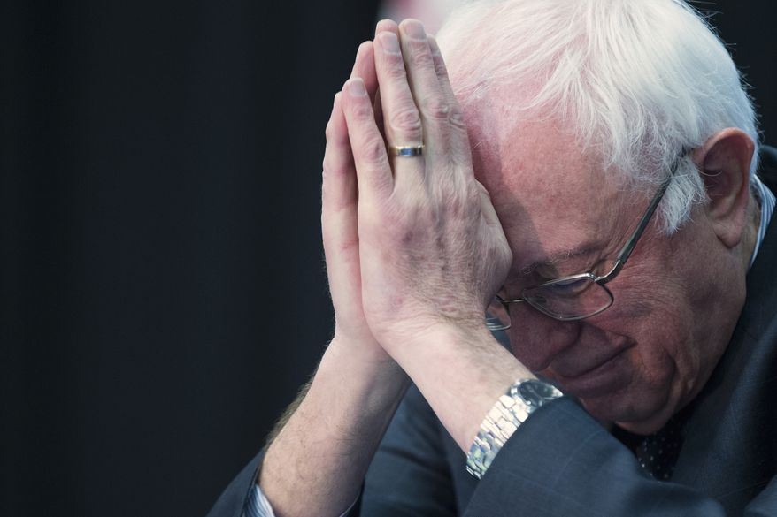 Democratic presidential candidate, Sen. Bernie Sanders, I-Vt. bows his head during a prayer at a breakfast with faith leaders at Allen University, Tuesday, Feb. 16, 2016, in Columbia, S.C. (AP Photo/Evan Vucci)