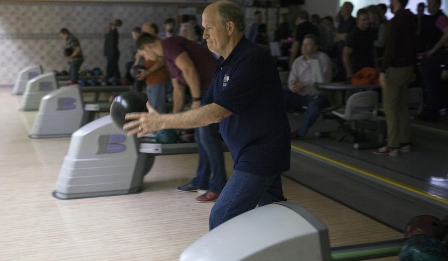 In this Feb. 4, 2016, photo, Alaska Gov. Bill Walker bowls with fellow legislators and staff in Juneau, Alaska. It was his first night of bowling with the legislative bowling leagues. Bipartisan, bicameral bowling has been a staple of Alaska’s legislative session for nearly 30 years. (AP Photo/Rashah McChesney)