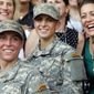 In this Aug. 21, 2015, file photo, Army 1st Lt. Shaye Haver, center, and Capt. Kristen Griest, right, pose for photos with other female West Point alumni after an Army Ranger school graduation ceremony at Fort Benning, Ga. In a Feb. 25, 2021 essay for West Point&#39;s Modern War Institute, Capt. Griest said the Army shouldn&#39;t go back to the old system where men and women were graded differently on PT tests.  (AP Photo/John Bazemore, File)   **FILE**