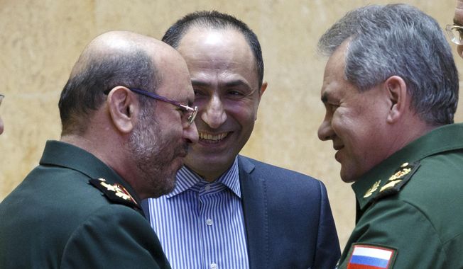 Russian Defense Minister Sergei Shoigu, right, and Iranian Defense Minister Hossein Dehghan shake hands during their meeting in Moscow, Russia, Tuesday, Feb. 16, 2016.  The Iranian defense minister is visiting Moscow for talks about closer military cooperation. (Vadim Savitsky/ Russian Defense Ministry Press Service pool photo via AP)