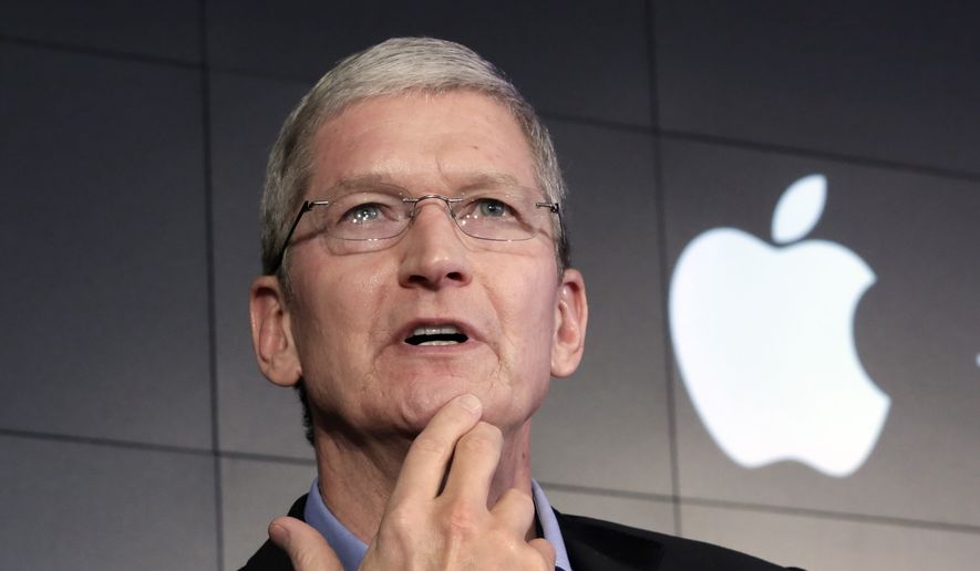 In this April 30, 2015, file photo, Apple CEO Tim Cook responds to a question during a news conference at IBM Watson headquarters, in New York. (AP Photo/Richard Drew, File)