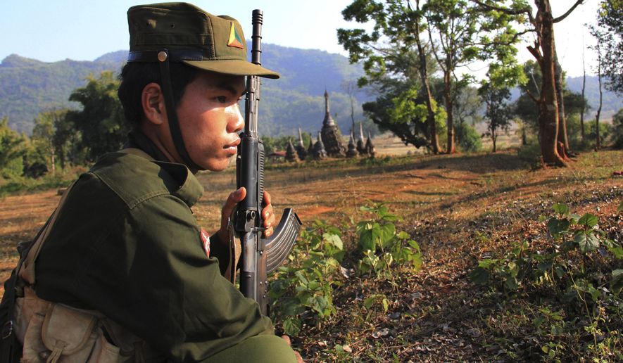 In this Feb. 4, 2016, photo, a rebel fighter of the Shan State Army North (SSA-N) stands guard close to the front line of the fighting area in Mong Ark, in an area under the control of SSA-N in northeastern Shan state, Myanmar. Myanmar’s civil war - the longest in modern world history - hasn’t ended, even with democracy triumphant in recent elections and the winner, Aung San Suu Kyi, pledging to end hostilities between the central government and a host of autonomy-seeking ethnic minorities. Prospects for stopping the bloodshed are balanced on a knife’s edge. (AP Photo/Esther Htusan)