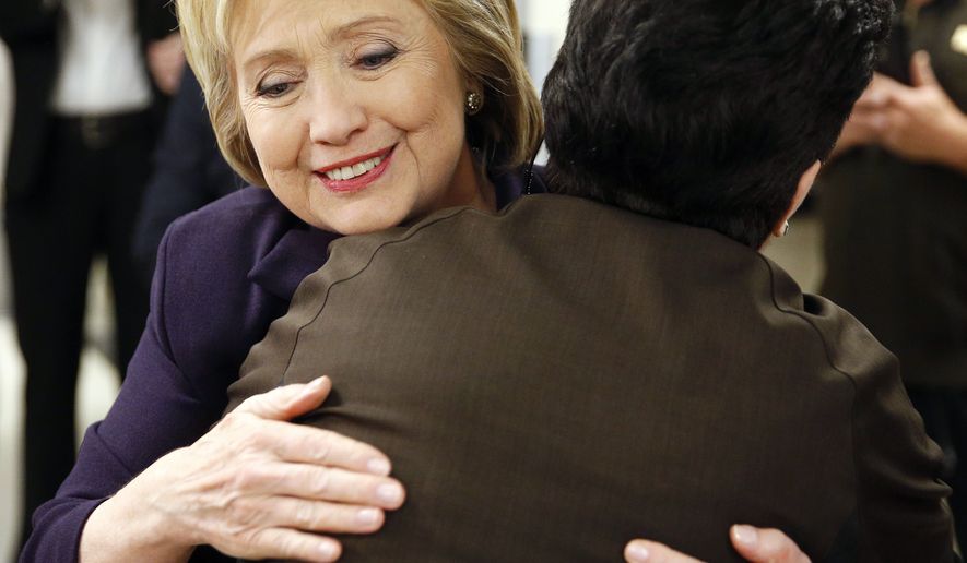 Democratic presidential candidate Hillary Clinton hugs an employee of Paris Las Vegas during a visit to the hotel and casino Thursday, Feb. 18, 2016, in Las Vegas. (AP Photo/John Locher)
