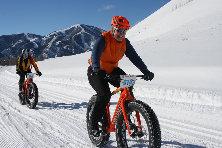 CORRECTS STATE TO IDAHO AND SOURCE TO IDAHO STATESMAN - In this Jan. 30, 2016 photo, Karen Dreher, right, and Nicole Legacy Toeldte compete in the Snowball Special fat bike race at Sun Valley Resort in Idaho. (Chadd Cripe/Idaho Statesman via AP) MANDATORY CREDIT