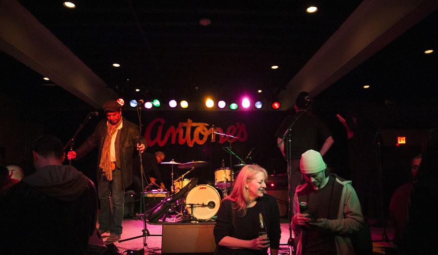 Michelle Mayberry, left, talks to Ian Currie in front of the stage on Friday, Jan. 15, 2016 at Antone's in Austin, Texas. Blues master Gary Clark Jr. helped revive Austin’s fabled blues club Antone’s two years after club closed in 2006, 5 years after death of founder Clifford Antone. (Kelly West /Austin American-Statesman via AP) AUSTIN CHRONICLE OUT, COMMUNITY IMPACT OUT, INTERNET AND TV MUST CREDIT PHOTOGRAPHER AND STATESMAN.COM, MAGS OUT; MANDATORY CREDIT
