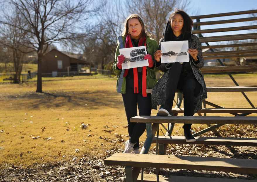 In this photo taken on Monday, Feb. 8, 2016, two public artists, Cynthia Mulcahy, left, and Lauren Woods pose in Moore Park, south of downtown Dallas. The pair have been researching Dallas' "Negro parks" and writing markers to honor their history. They say their research has been censored and stolen by the two foundations who funded the project. They say the foundations want to gloss over uncomfortable parts of Dallas' past, the decades when public parks were segregated. (Tom Fox/The Dallas Morning News via AP) MANDATORY CREDIT; MAGS OUT; TV OUT; INTERNET USE BY AP MEMBERS ONLY; NO SALES