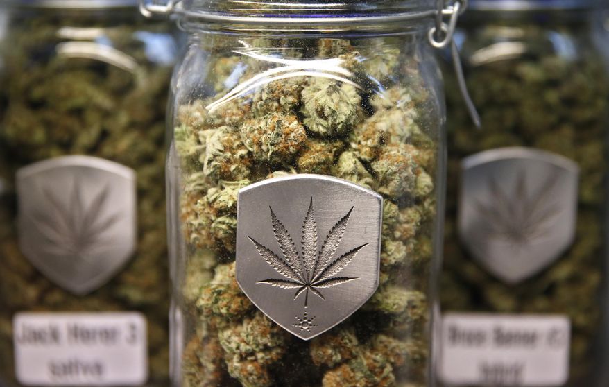 In this Dec. 27, 2013 file photo, different strains of pot are displayed for sale at a dispensary in Denver. (AP Photo/Brennan Linsley, file)