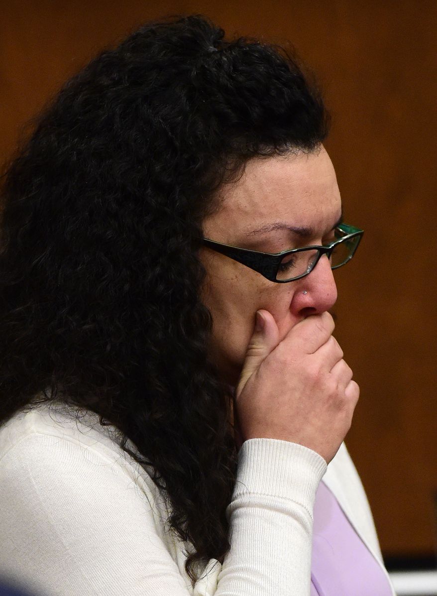 Dynel Lane reacts as a tape of her talking with a Longmont Detective is played during her trial, Friday, Feb. 19, 2016, in Boulder, Colo. Lane is charged with attempted first-degree murder, assault and unlawful termination of a pregnancy in the 2015 attack on Michelle Wilkins in Longmont, Colo. (Matthew Jonas/Daily Camera via AP)